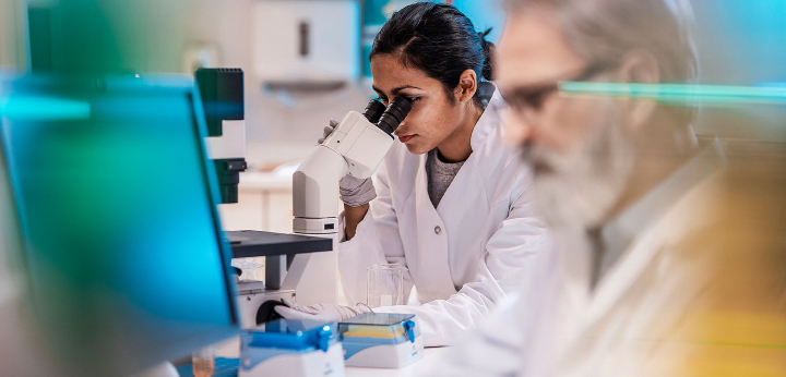 lab technician with microscope